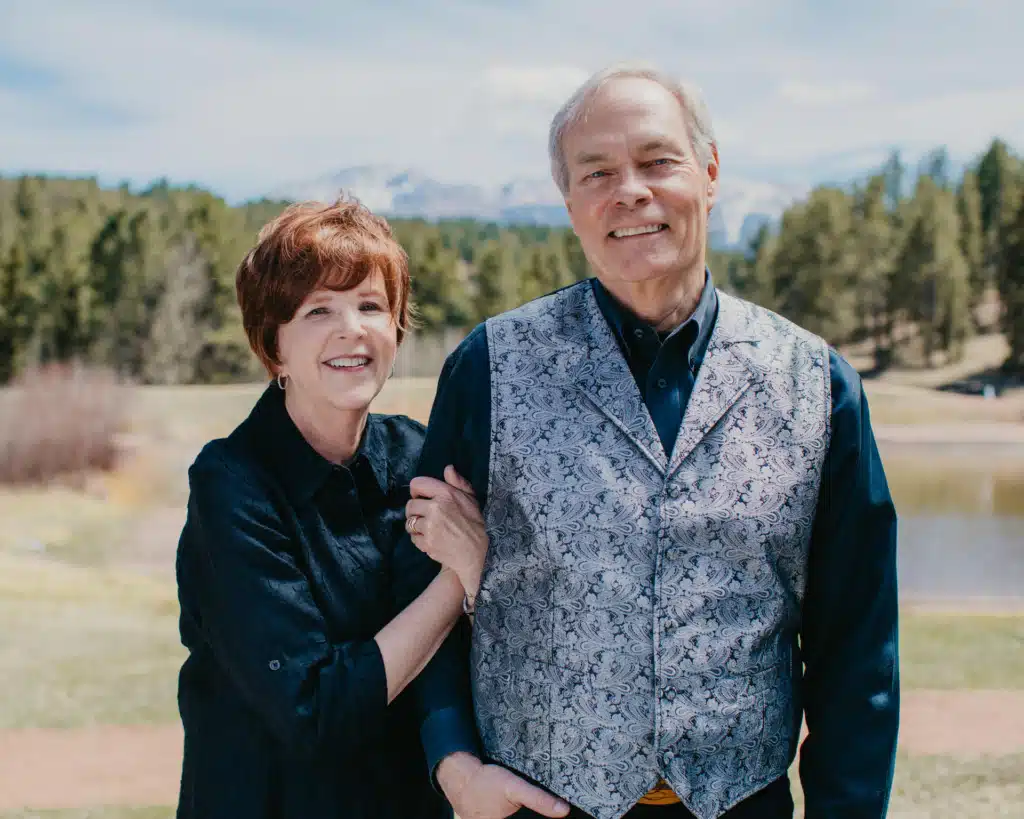 Andrew and Jamie Wommack standing at a wooden railing